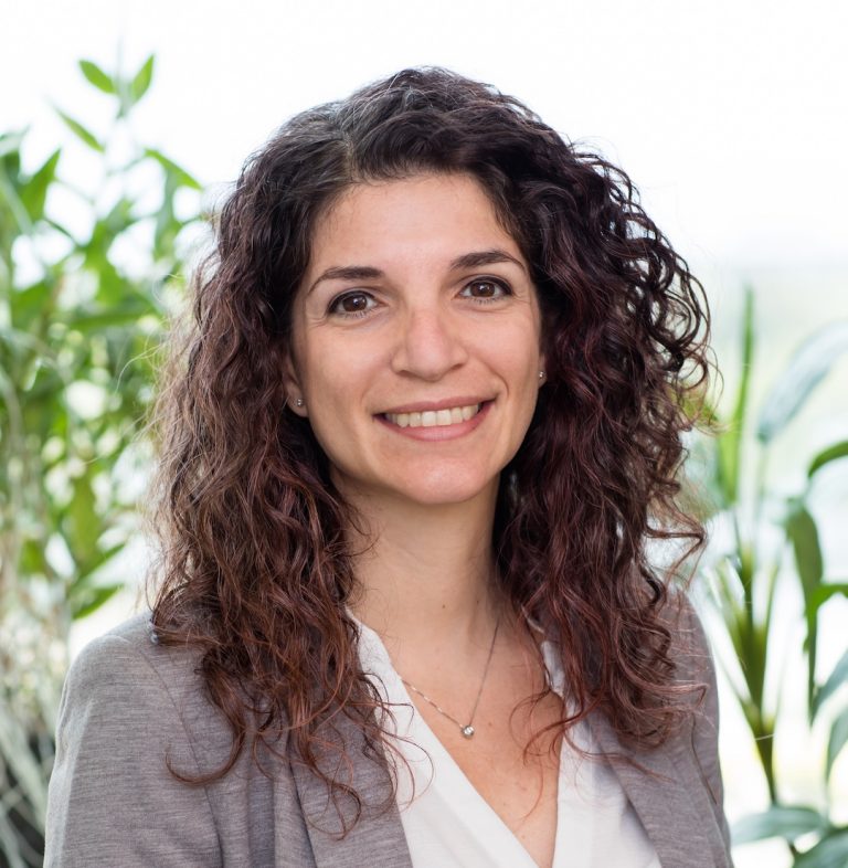 Portrait photo of Alba Grifoni. She is facing the camera and smiling