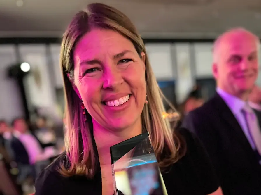 Photo of Erica Ollmann Saphire, Ph.D., MBA, holding her award from California Life Sciences