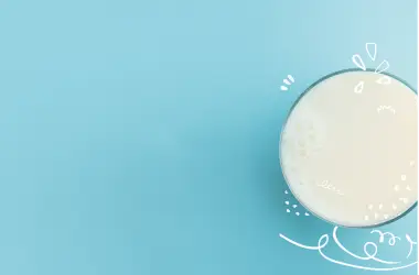 A glass of milk on a blue background