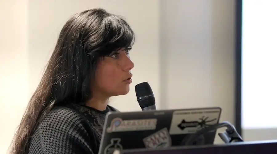 Photo of Rosa Isela Gálvez, Ph.D., speaking into a microphone at an event