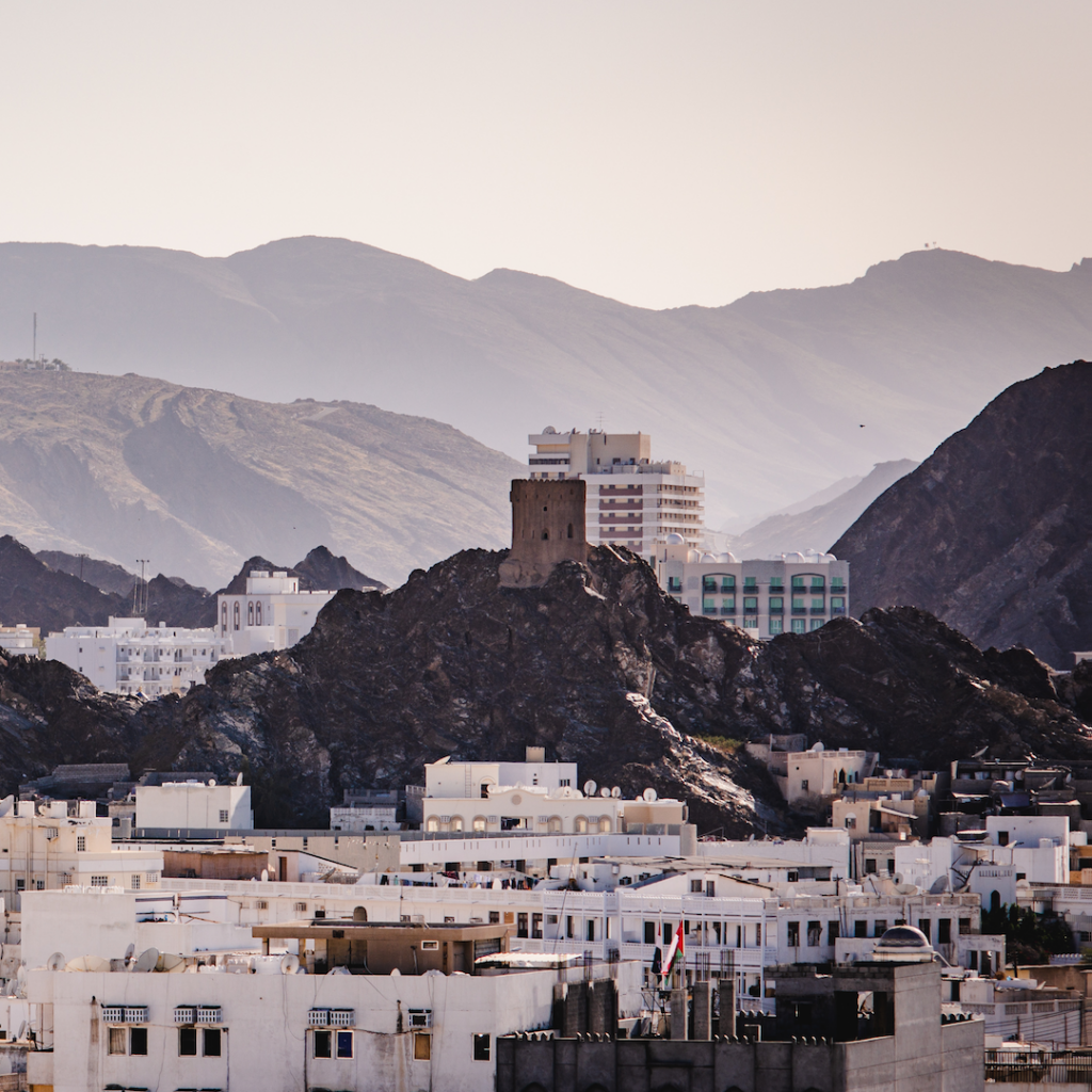 A blending of mountains and architecture in Muscat, Oman. Photo by Dawid Zyla.