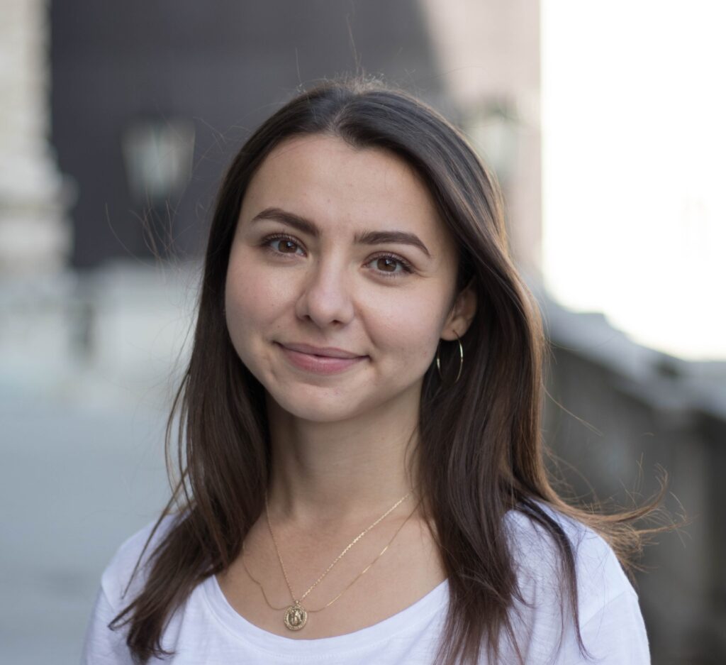 Photo portrait of Julia Timis. Timis is looking at the camera and smiling