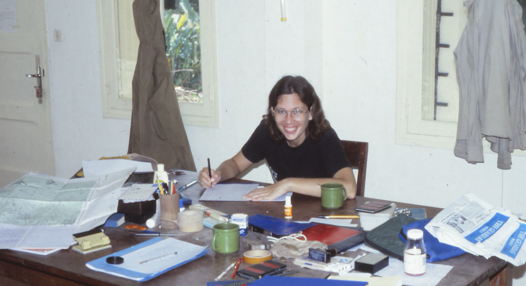 Karen Barnes at a table, surrounded by paperwork
