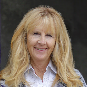 Photo portrait of Dr. Emily Holmes. She is facing the camera and smiling