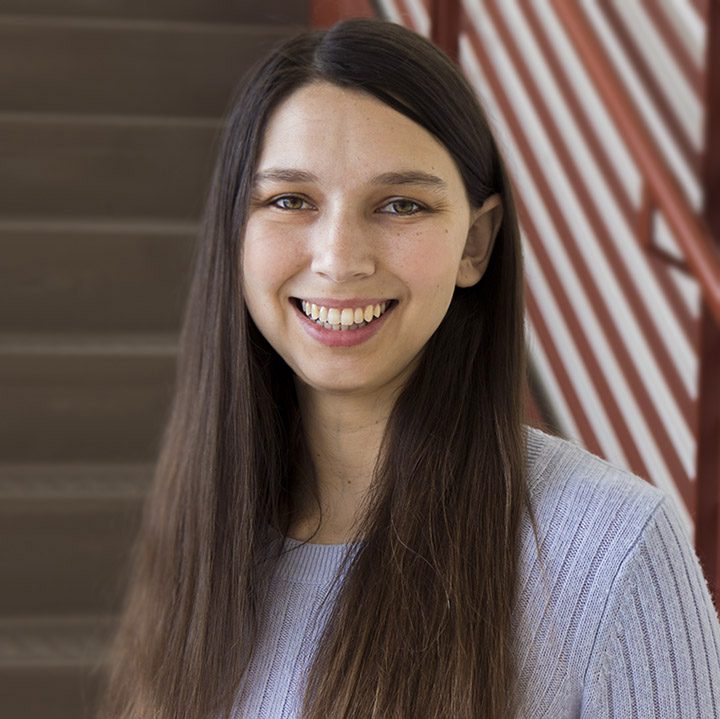 Portrait photo of Sara McArdle, Ph.D. She is smiling at the camera